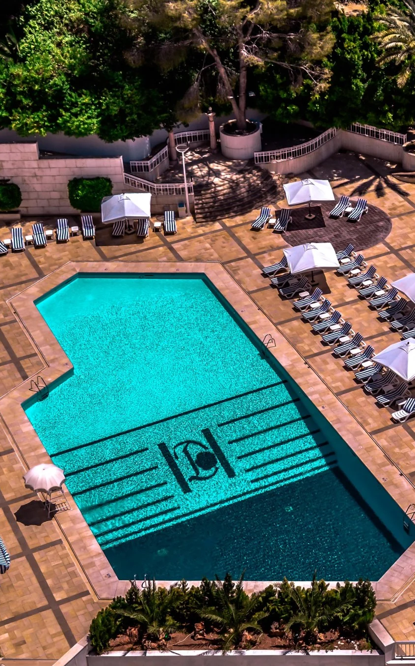 Aerial view of Aqua Rose outdoor swimming pool and lounge area at Damarose Hotel